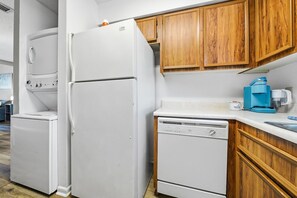 A compact kitchen with a refrigerator, dishwasher, and coffee maker. - Skiff F7 in Saint Simons Island, GA (Saint Simons Island)