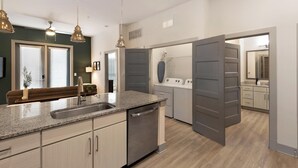 A modern kitchen with granite countertops, stainless steel appliances, and a built-in dishwasher. - Landing | Spectacular 2BD, Yoga Studio, Clubhouse (Charlotte)