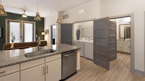 A modern kitchen with granite countertops, stainless steel appliances, and a built-in dishwasher. - Landing | Spectacular 2BD, Yoga Studio, Clubhouse (Charlotte)