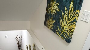 A staircase with a modern design, a wall-mounted artwork, and a minimalist decor.
