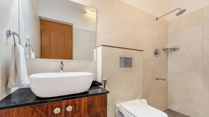 A modern bathroom with a freestanding sink, a toilet, and a shower. - Brook Stone Villas By Rai Hospitality (Madikeri)