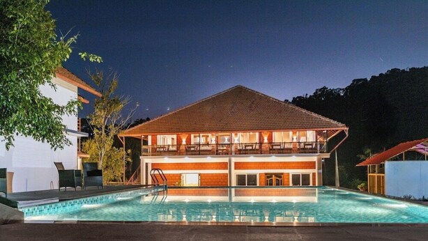 A two-story building with a swimming pool in front. - Brook Stone Villas By Rai Hospitality (Madikeri)