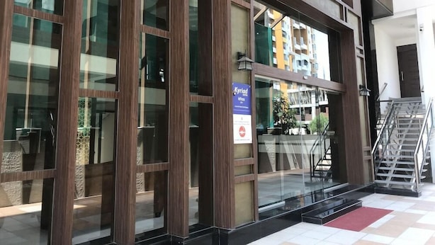 Un edificio moderno con amplios ventanales y un letrero que indica una ubicación.