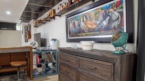A room with a wooden desk, a large painting, a vintage fan, and a cabinet with drawers. - Near NYC & Metro-North! Private Yonkers Studio (Yonkers)