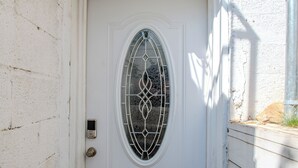 A white door with a decorative glass panel and a keypad lock. - Near NYC & Metro-North! Private Yonkers Studio (Yonkers)