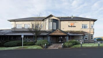 A two-story building with a sign reading 'Beefeater The Newhouse.'