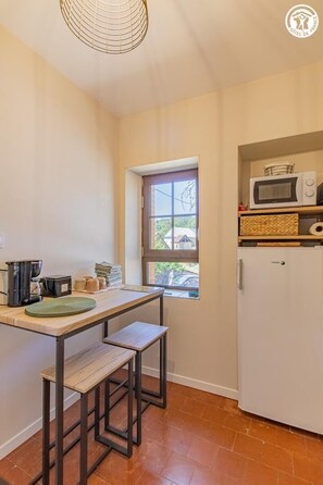 A compact kitchen with a window, a microwave, and a refrigerator. - Gîte du Promeneur - CUSSY EN MORVAN (CUSSY EN MORVAN)