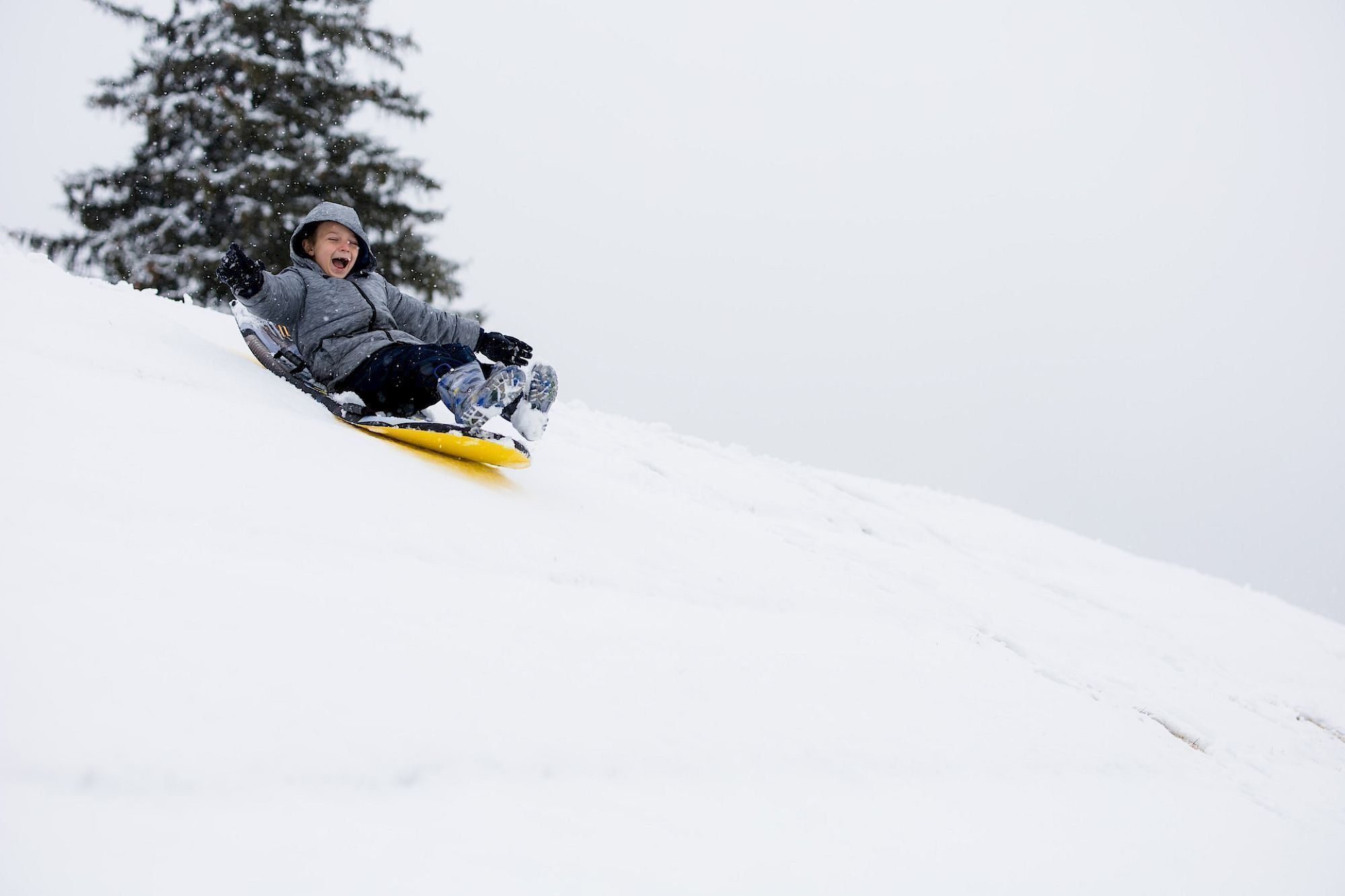 A person snowboarding down a snowy slope.