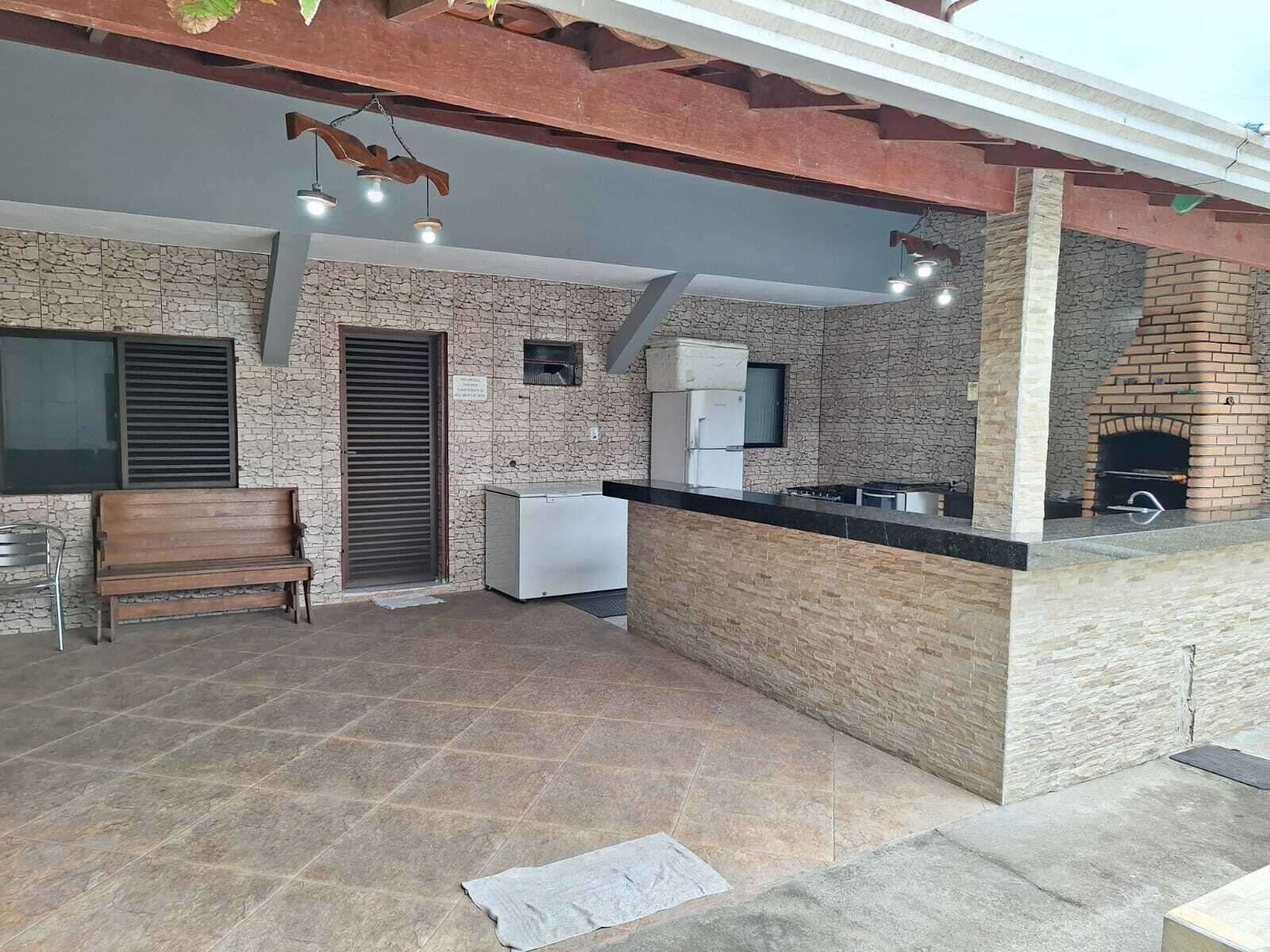 A kitchen area with a stone wall, a built-in oven, and a wooden bench.