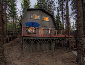 A cabin with a deck, surrounded by tall trees. - Tree Top Verdon - 5bdr With Sauna (South Lake Tahoe)