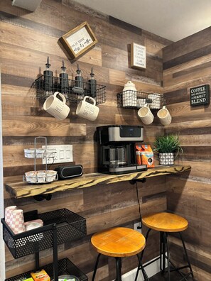 A kitchen area with a coffee machine, mugs, and a sign that says 'Coffee and friends a perfect blend.' - Private cabin retreat with everything you need! (Independence)