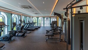 A gym with treadmills, elliptical machines, and weightlifting equipment. - The Title Legendary 2BR, 5 Min to Bang Tao Beach (Tambon Choeng Thale)