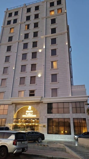 A multi-story hotel with a modern design, featuring a prominent entrance with illuminated signage. - Enala Hotel EL Khobar (Al Khobar)