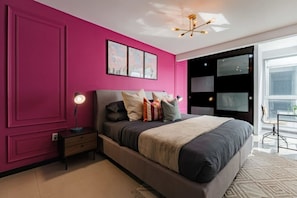 A modern bedroom with a large bed, a bedside table with a lamp, and a window with a view. - Private Terrace Escape in the Heart of Roma Norte (Mexico City)