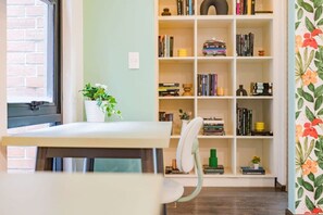 A room with a desk, chair, bookshelf, and a window. - Best for Groups in Roma Norte: Parking, Workspaces (Mexico City)