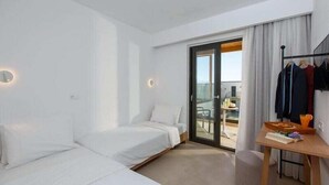 A hotel room with a bed, a desk, and a view of the outside. - Aloe Boutique Hotel Powered by Anissa Beach (Hersonissos)