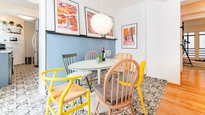 A dining area with a round table, chairs, and framed pictures on the wall. - Vibrant Condo in Roma Norte Walk to Museums & Eats (Mexico City)