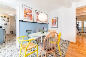 A dining area with a round table, chairs, and framed pictures on the wall. - Vibrant Condo in Roma Norte Walk to Museums & Eats (Mexico City)