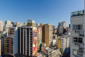 A cityscape with high-rise buildings, one featuring a large mural. - Studio w/ Pool Near Redencao Park Tco1216 (Porto Alegre)