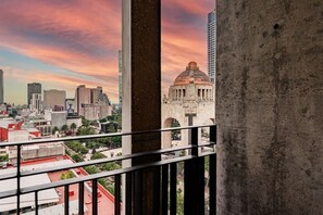 A cityscape with a prominent dome structure, high-rise buildings, and a balcony railing. - Stylish 1BR • Gym & Workspace • Near Reforma (Mexico City)