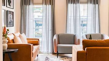 Uma sala de estar moderna com sofá, poltronas e mesa de centro.