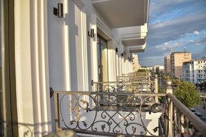 A balcony with ornate metal railings and a view of a cityscape. - Hotel Lubjana (Durrës)