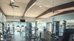 A gym with ceiling fans, exercise equipment, and large windows. - Spacious 1 bedroom apartment in awesome Sarasota with swim pool and fitness room (Sarasota)
