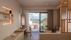 A modern hotel room with a balcony, a desk, and seating area.
