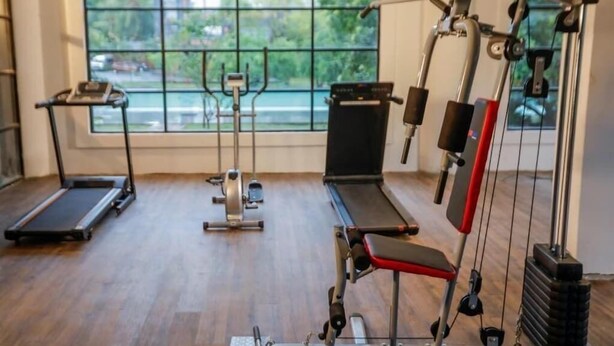 A gym with treadmills, a rowing machine, and a bench press. - Covanro Sigiriya (Avudangawa)