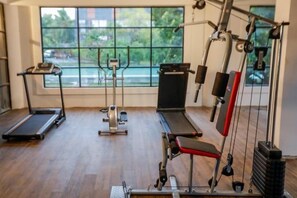 A gym with treadmills, a rowing machine, and a bench press. - Covanro Sigiriya (Avudangawa)