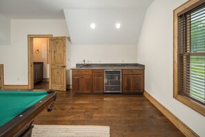 The wet bar keeps drinks and ice close to the table, with a glass-front fridge stocked and ready. - Buffalo Whiskey Soak Above the Clouds at a Luxe 5BR Eagle's Nest Lodge (Banner Elk)