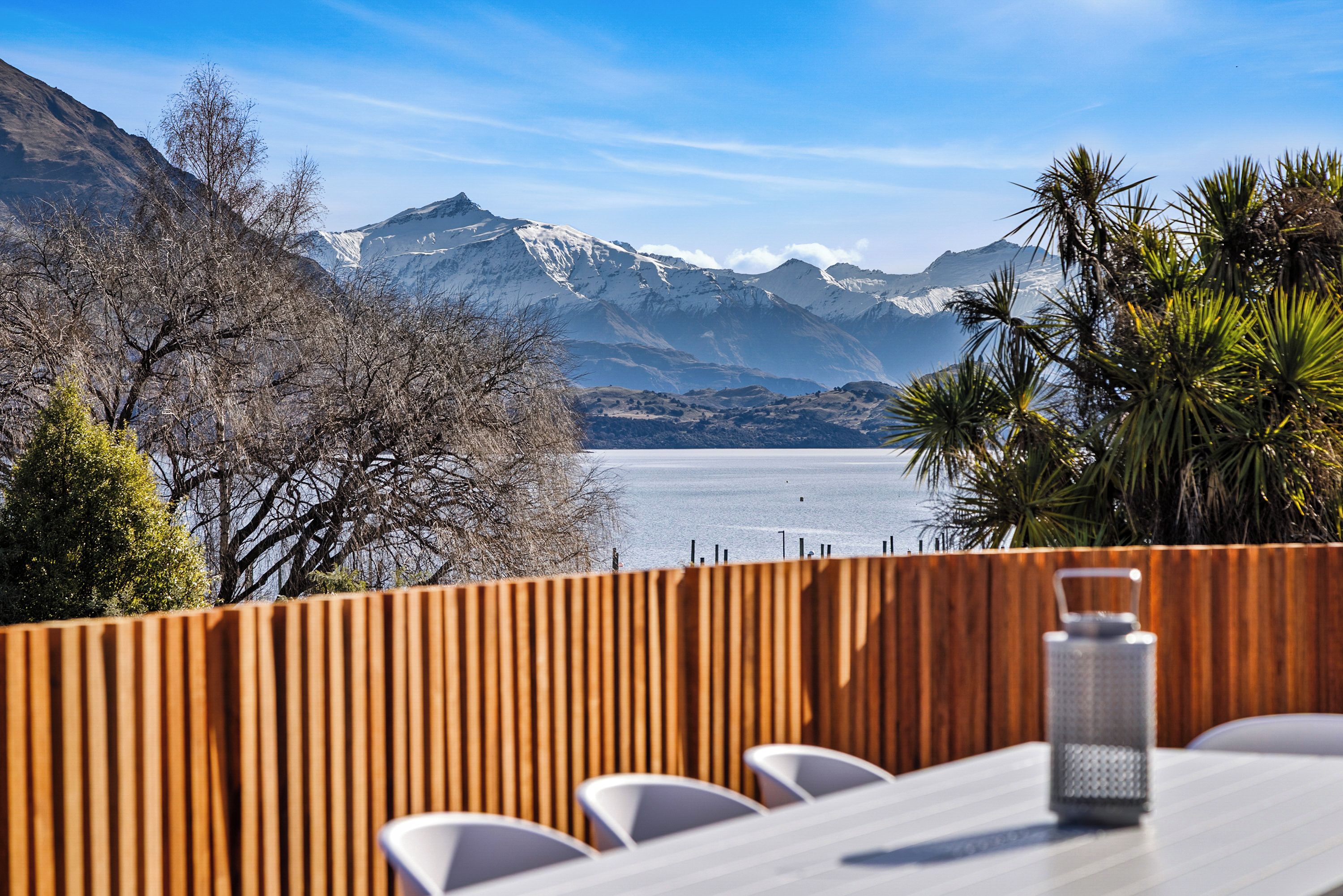 A dining area with a view of mountains and a lake.