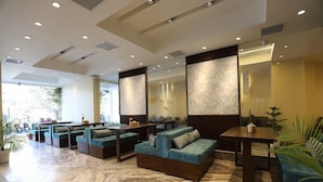 A modern lobby with seating areas, a marble floor, and large windows. - Apex Business Hotel (Kathmandu)