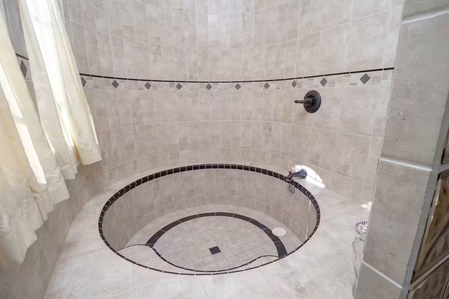 Ein Badezimmer mit freistehender Badewanne, gefliesten Wänden und einer Duschkabine.