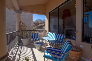 A balcony with outdoor seating, a potted plant, and a view of the surrounding landscape. - Ocean & Mountain View Retreat (San Carlos Nuevo Guaymas)