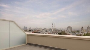 A cityscape view from a balcony with a clear sky. - Moxy Istanbul Beyoglu (Istanbul)