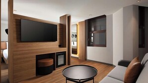 A modern living room with a flat-screen TV, a round coffee table, and a sofa. - Moxy Istanbul Beyoglu (Istanbul)