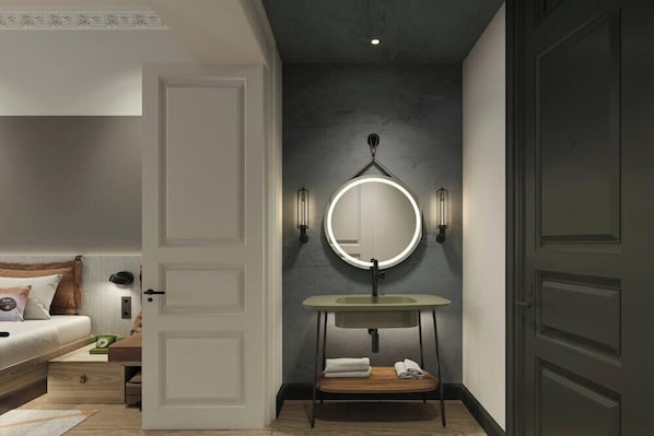 A modern bathroom with a round mirror, wall-mounted lights, and a wooden vanity. - Moxy Istanbul Beyoglu (Istanbul)