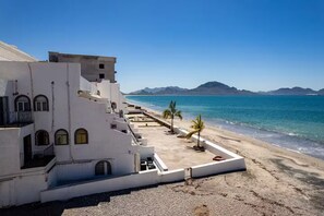 A coastal building with a balcony overlooking a beach and the sea. - Mediterranean Scape (San arlos Nuevo Guaymas)