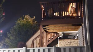 A residential building with a wooden balcony and a white fence. - Coastal Comfort - 2BR/2BA Condo in North OCMD - Walk to Beach, Dining & Fun (Ocean City)