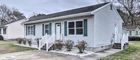 A single-story house with a front porch, a small front yard, and a driveway.