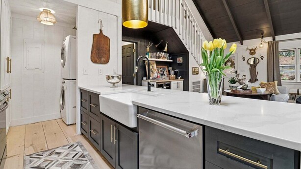 A kitchen with a large island, stainless steel appliances, and a hanging light fixture. - Long & Short of It - Pet Friendly, EV Charger, Firepit + Big Canoe Access (Jasper)
