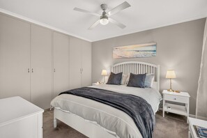 A bedroom with a bed, nightstands, a ceiling fan, and a painting on the wall. - Grace Cottage - Peaceful Vineyard Escape in the Barossa Valley (Penrice)