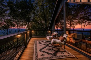 A deck with outdoor seating and a view of the landscape. - Painted Sky Cabin - Long Distance Mountain Views! | Firepit | Pet Friendly (Morganton)