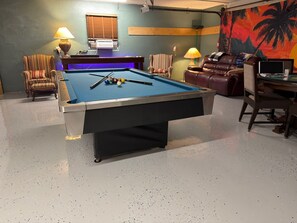 A pool table in a room with a sofa, armchairs, and a desk with a computer. - Private Pool • Game Room • Fire Pit • Boat Parking (Crystal River)