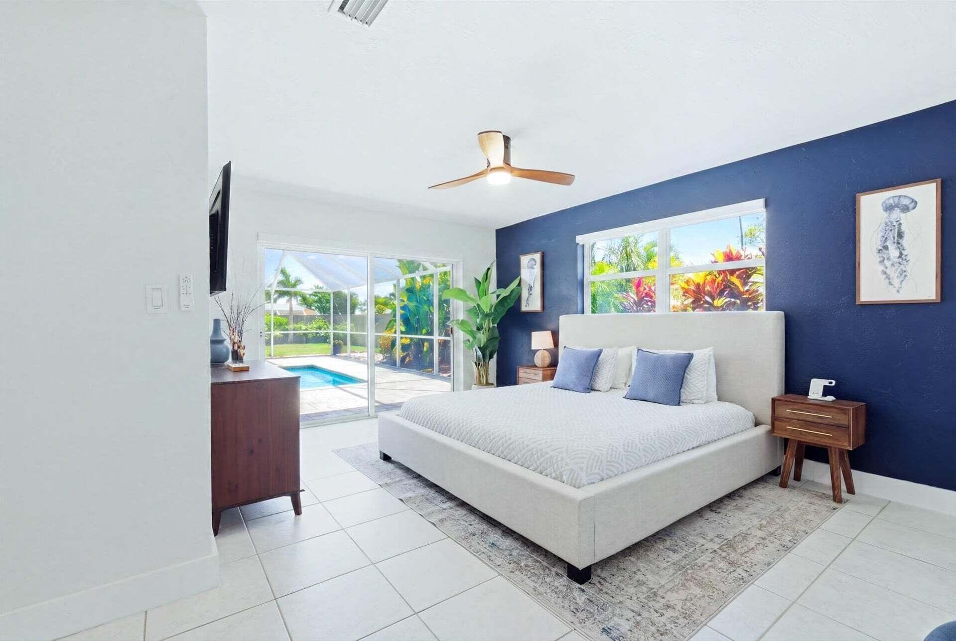 Primary bedroom with king bed, attached bathroom, lanai access and 55-inch Smart TV