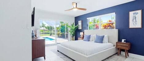 Primary bedroom with king bed, attached bathroom, lanai access and 55-inch Smart TV