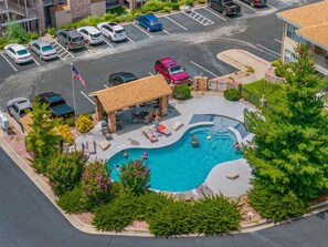 A swimming pool area with lounge chairs, a covered seating area, and a flag. - Club Yakov & 3BDR Lakefront (Hollister)