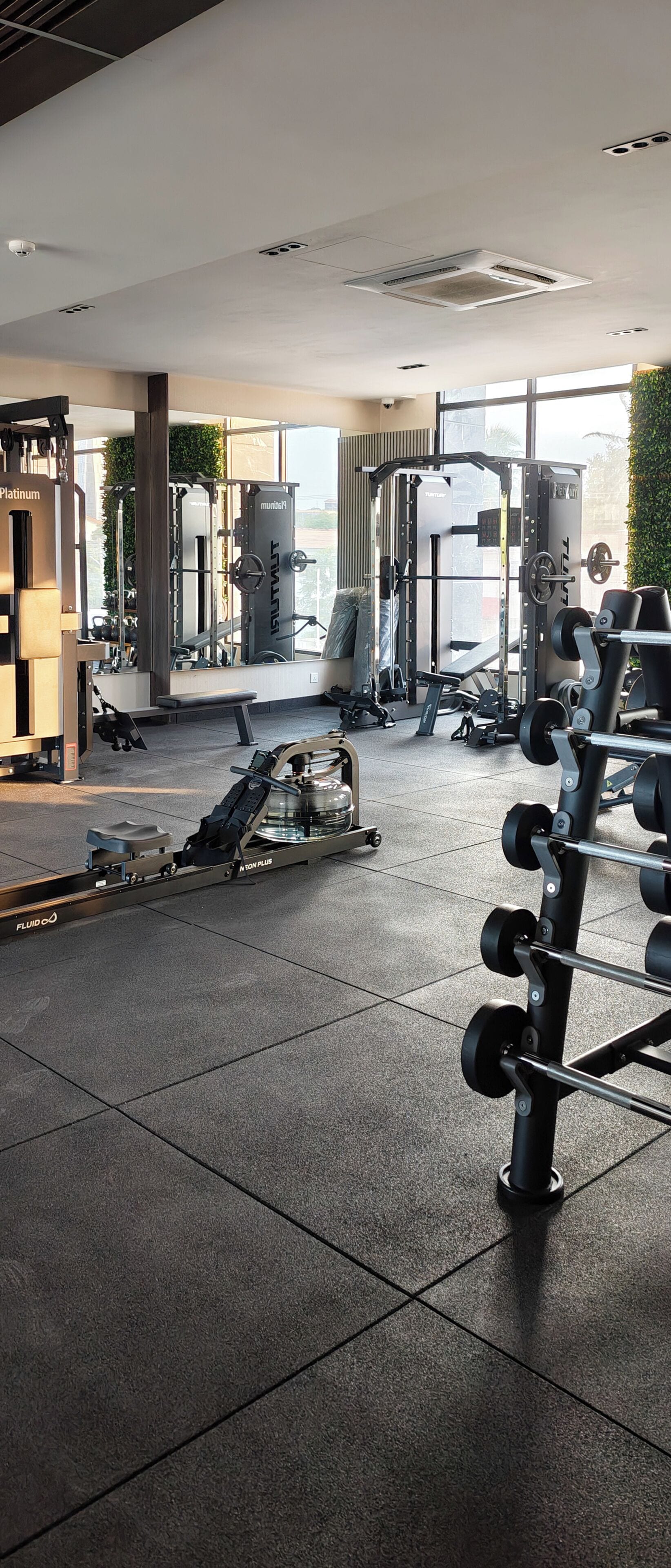 A gym with various exercise equipment, including weight machines and free weights.