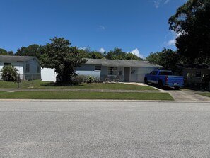 A residential driveway with a blue pickup truck parked on the side. - Quaint 3 bedroom 2 bath house centrally located in Saint Petersburg (Pinellas Park)
